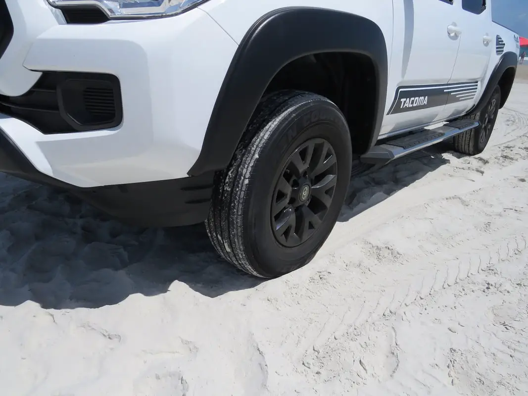 Sandy tires on a beach pickup truck