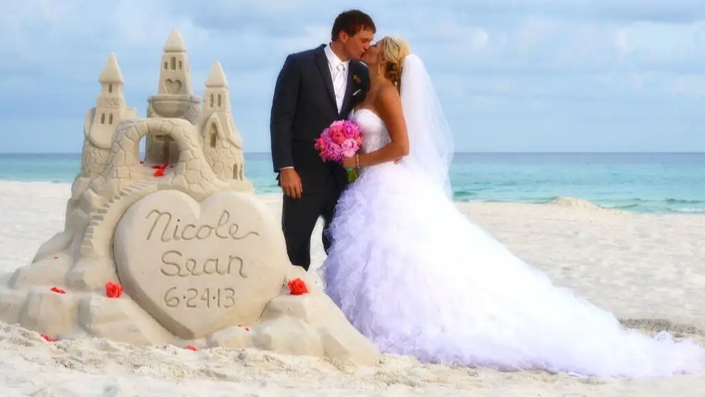 Destin Beach wedding couple with sandcastle