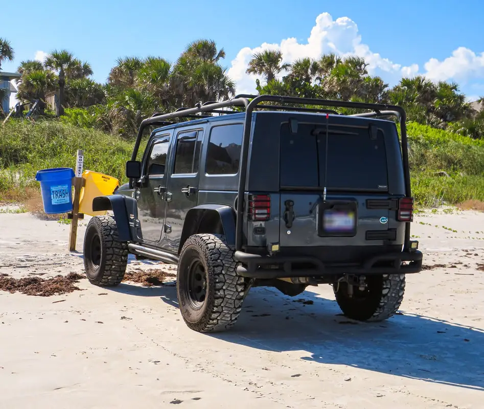 Jeep Wrangler parked on the sand