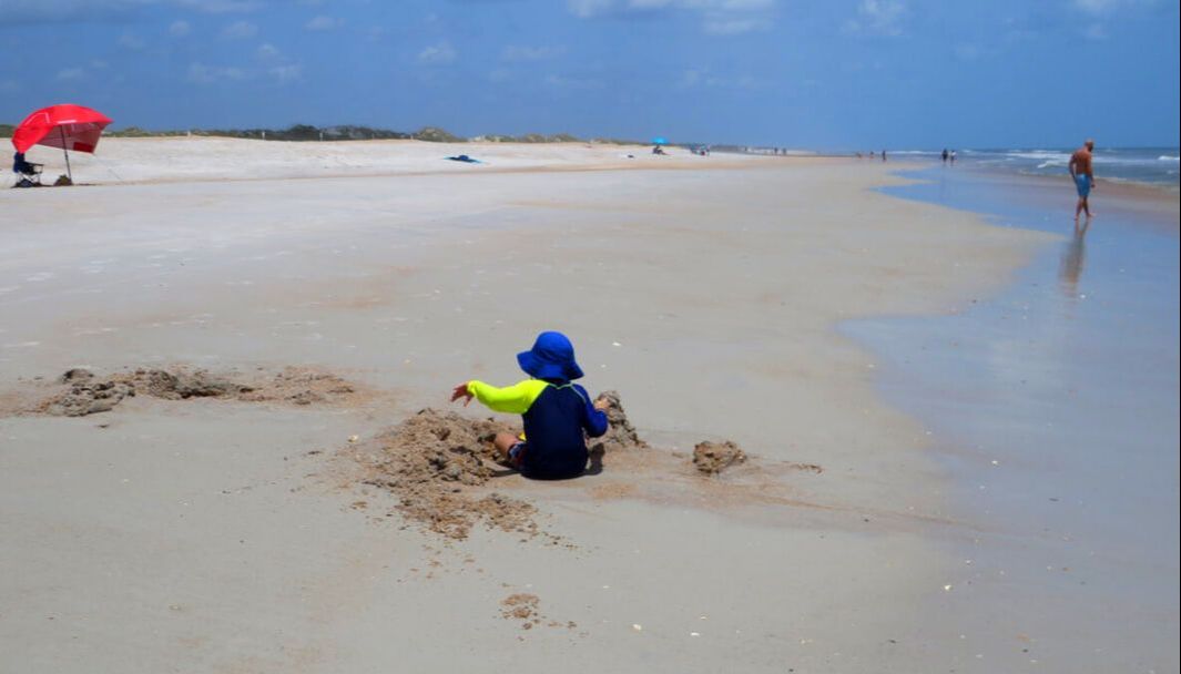 Picture child digging in sand Anastasia Island