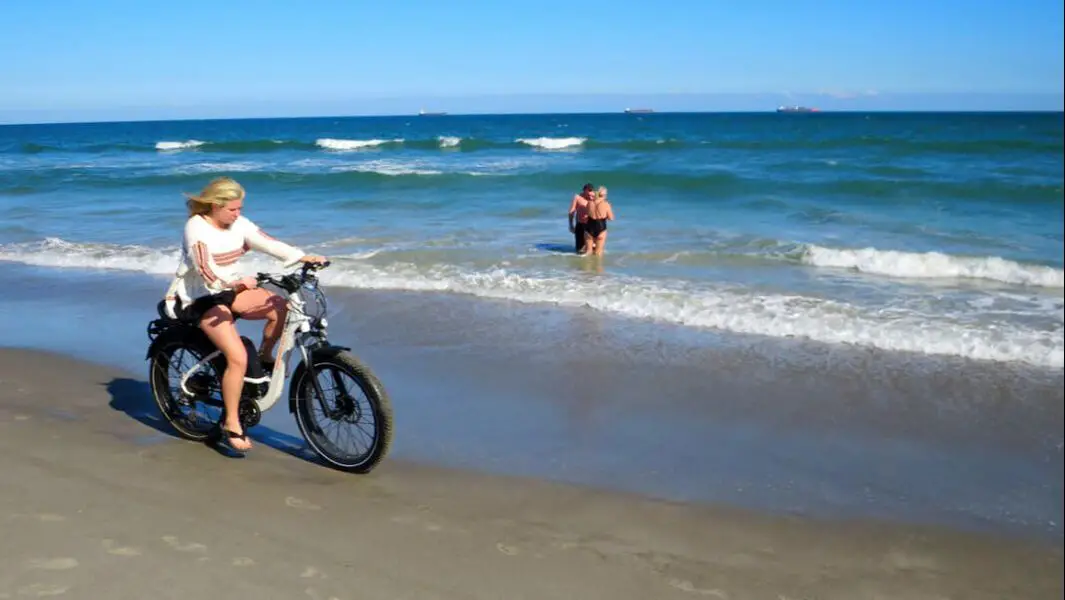 Woman rides bike on Cocoa Beach