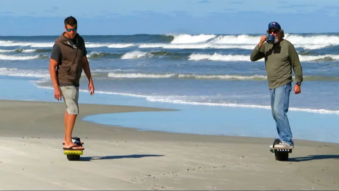 Two men on onewheels at New Smyrna Beach