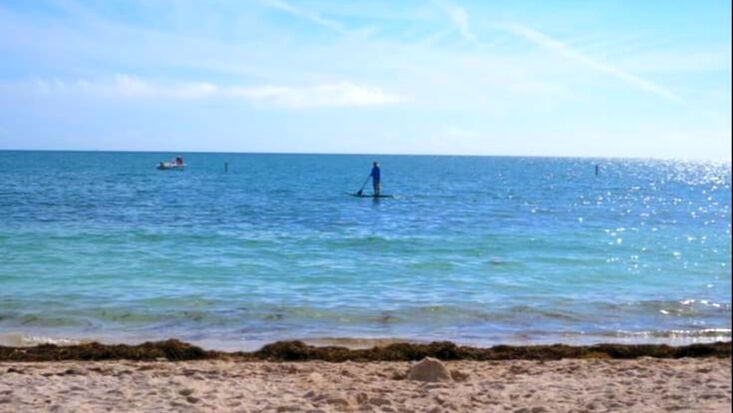 Man paddleboarding at Sombrero Beach FL