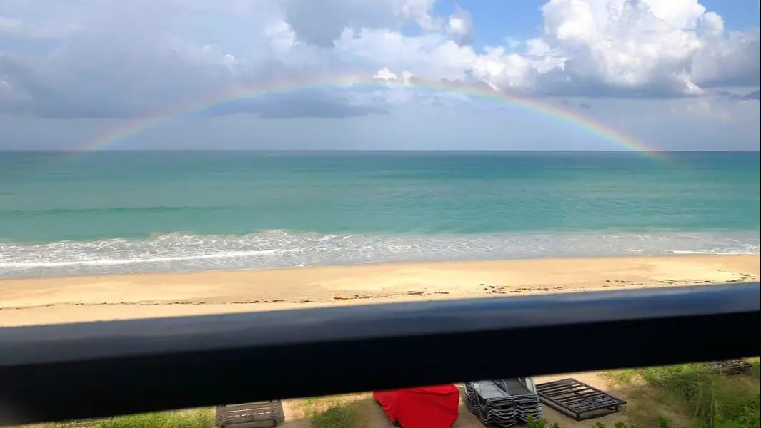 Jensen Beach shores with rainbow over water