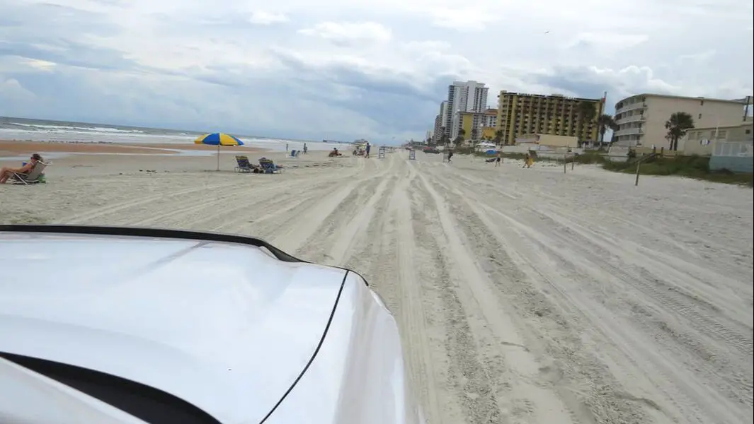 Truck hood view driving on beach sand