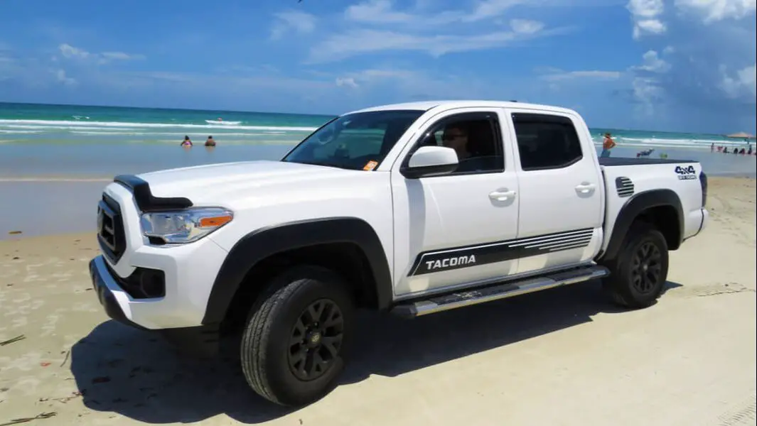 Toyota Tacoma pickup driving on beach