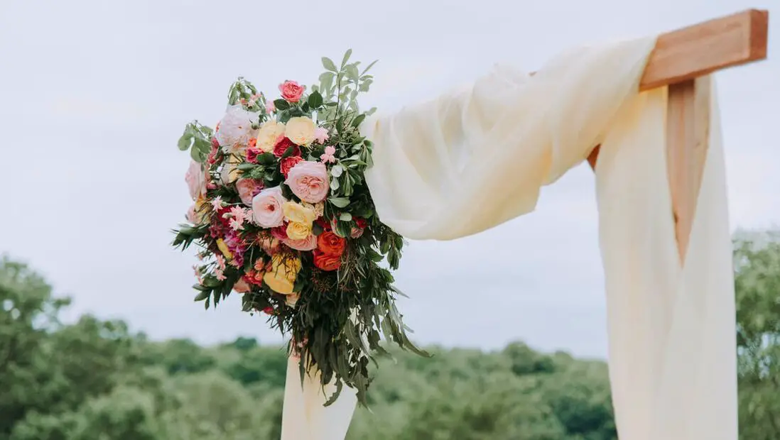 Picture of flowers on wooden wedding arch