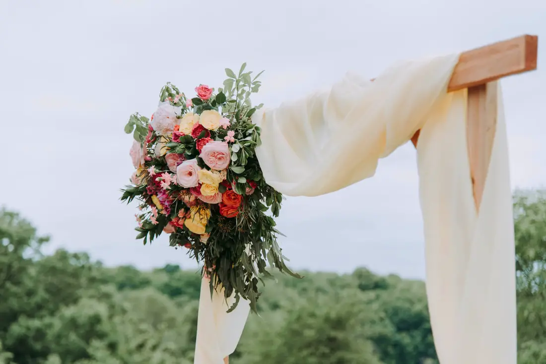 Picture of flowers on wooden wedding arch